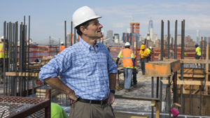 Eliot Spitzer at a construction site, wearing a hard hat