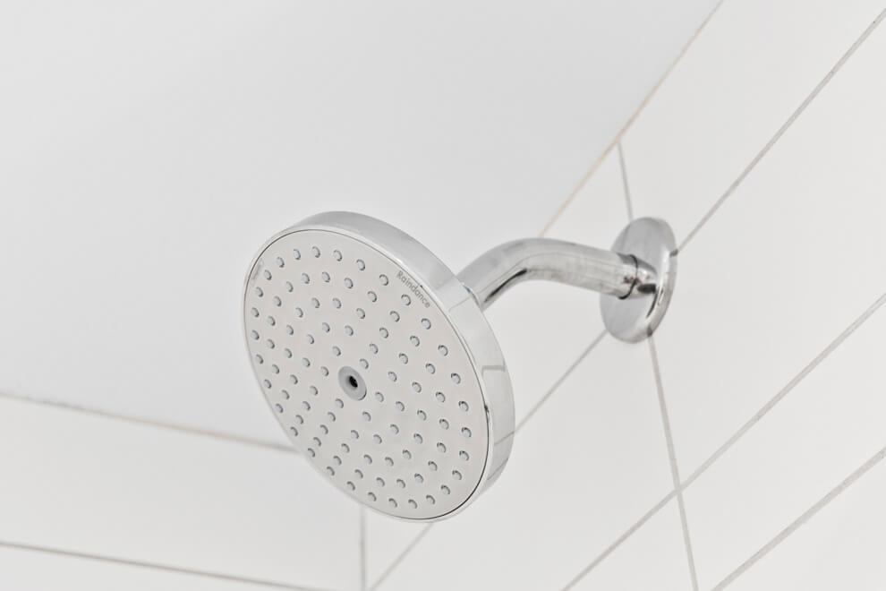 Polished chrome shower head in a 420 Kent bathroom