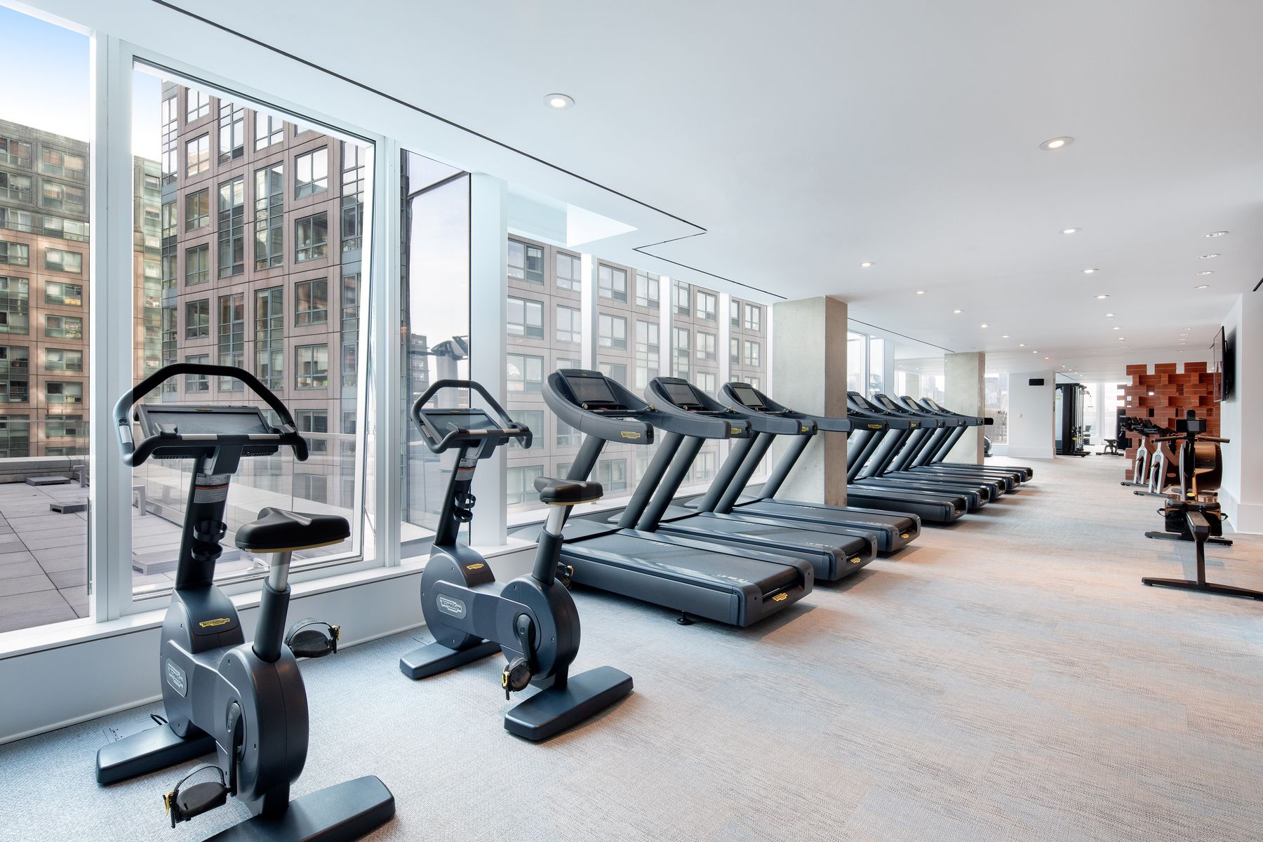 420 Kent - Fitness Center, bright with large windowed wall, ample treadmills, stationary bikes and other fitness equipment